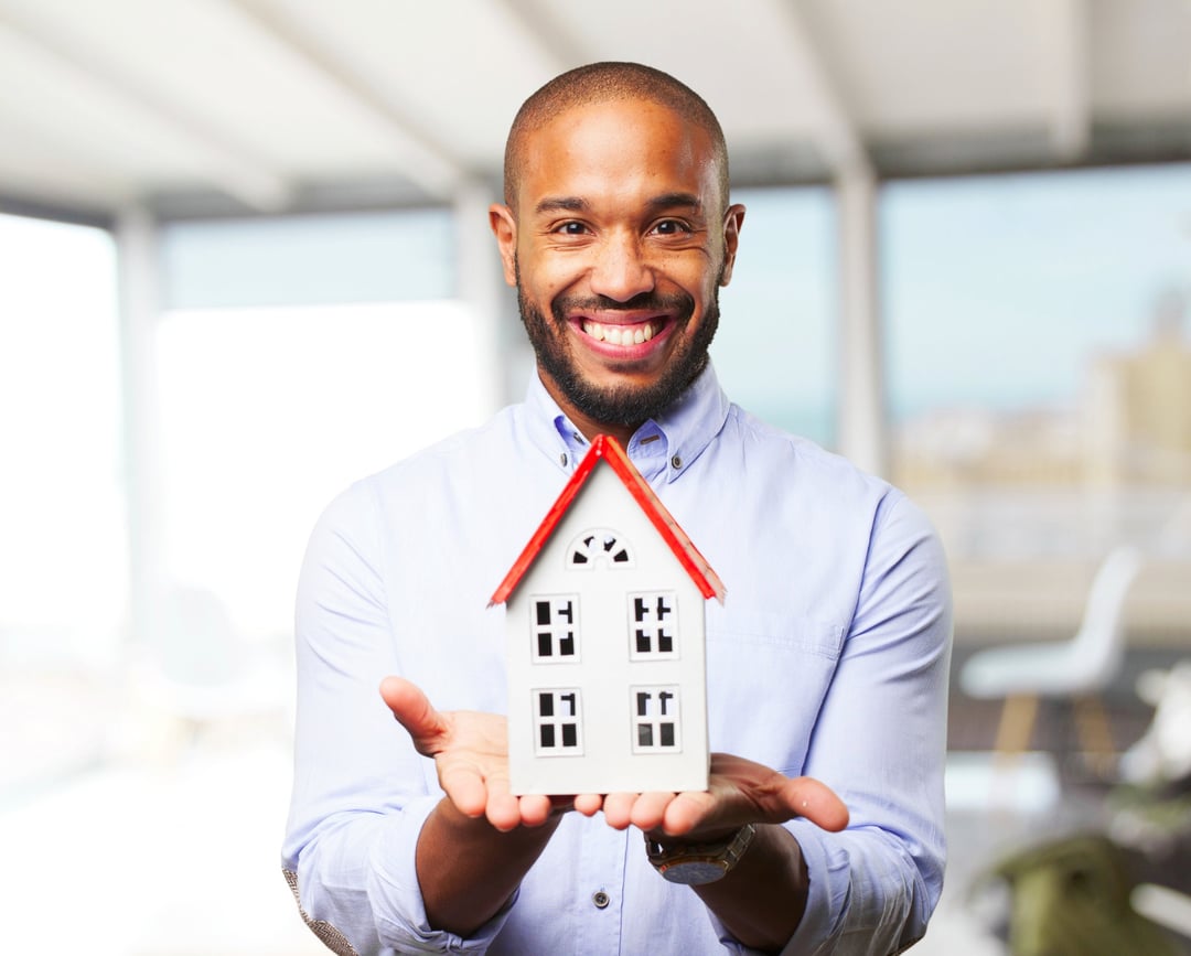Happy man with house model